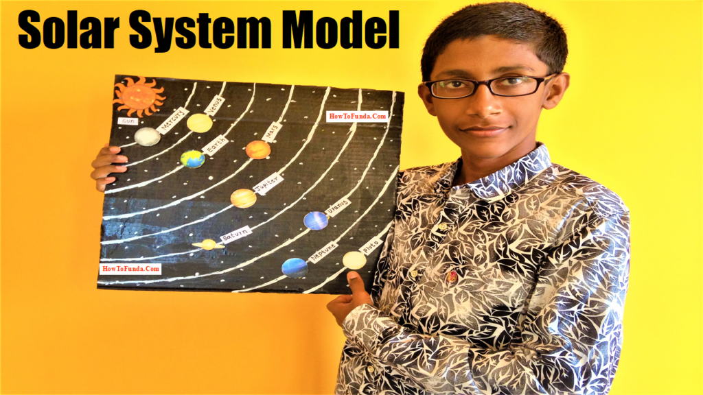 student holding the solar system model project for school science exhibition